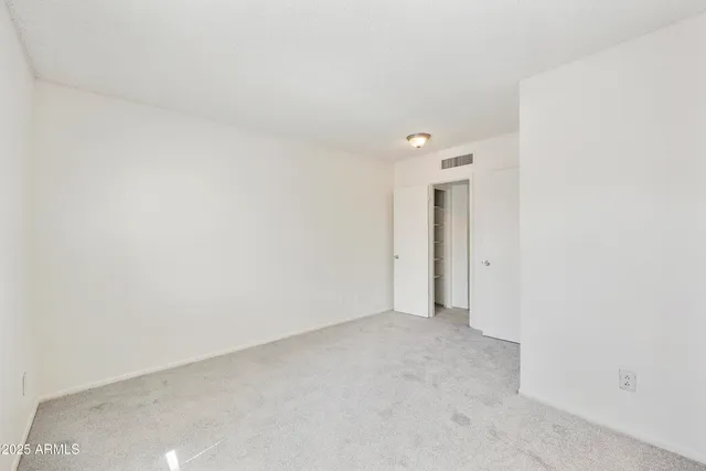 a view of a room with a ceiling fan and a window