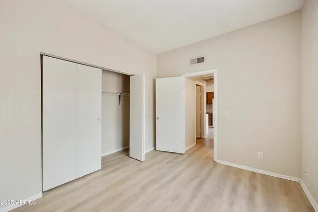 a kitchen with a sink a refrigerator and cabinets