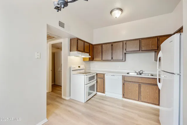 a kitchen with a stove cabinets and wooden floor
