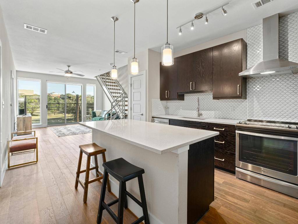 3114 South Congress Avenue, Unit 307 Austin, TX 78704 - Photo 4 of 19 a kitchen with a table chairs microwave and cabinets