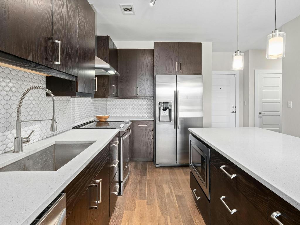 3114 South Congress Avenue, Unit 307 Austin, TX 78704 - Photo 5 of 19 a kitchen with a sink and a refrigerator