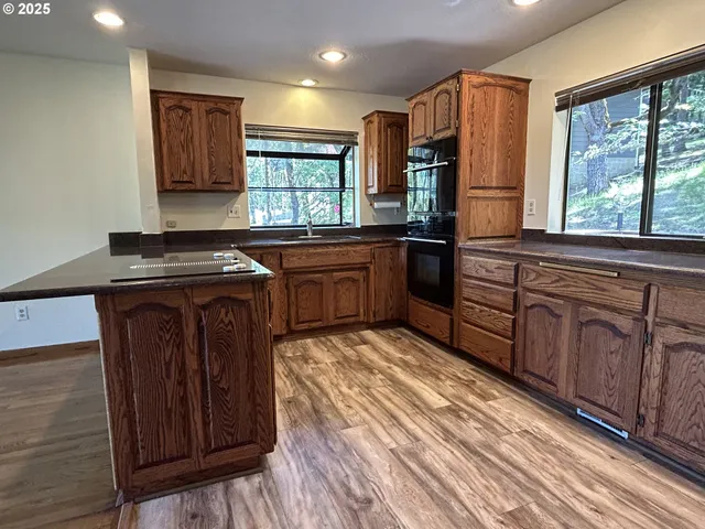 a kitchen with stainless steel appliances granite countertop a stove a sink and a refrigerator