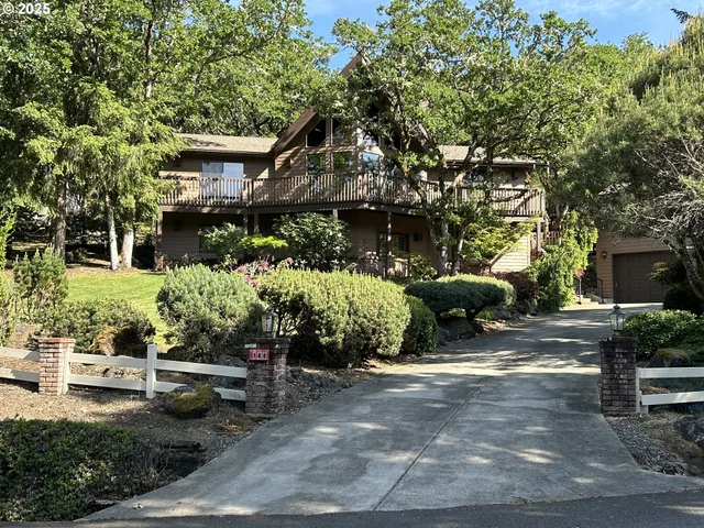 a view of a house with a yard and sitting area