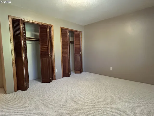 a bathroom with a granite countertop sink a toilet and mirror