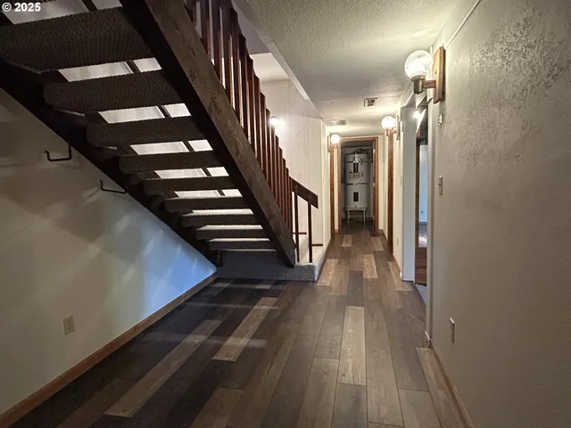 a view of entryway and hall with wooden floor