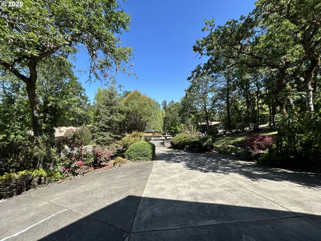 a white house with a tree in the background