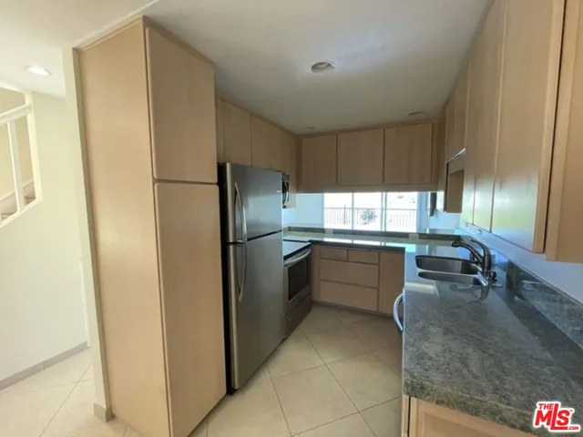 a kitchen with refrigerator and window