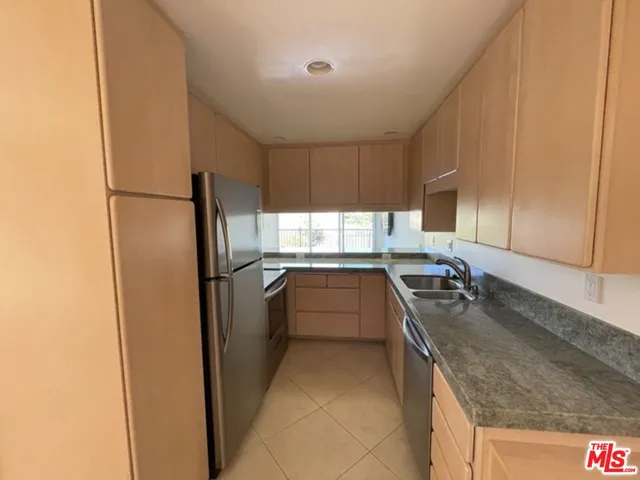 a kitchen with a refrigerator sink and stove