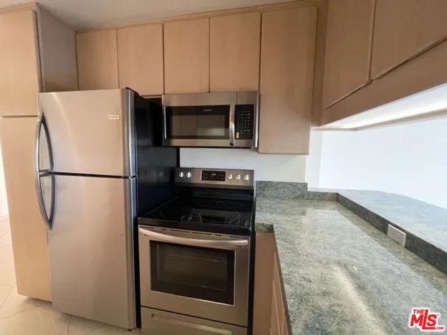 a kitchen with a refrigerator stove and microwave
