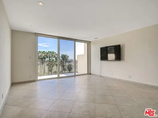 a view of a livingroom with an empty space and a flat screen tv