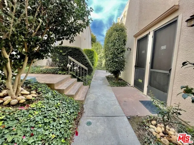 a view of a pathway both side of the house