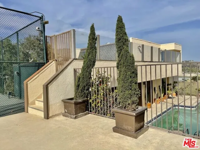a view of balcony with floor to ceiling window and outdoor kitchen