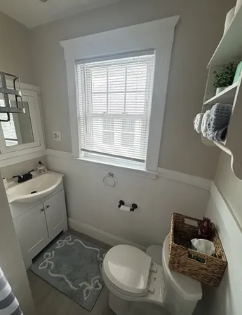 a bathroom with a toilet sink and mirror