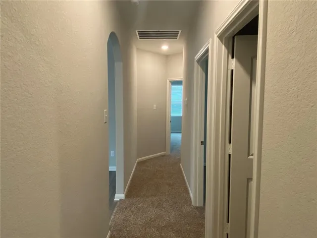 a view of a bathroom from a hallway