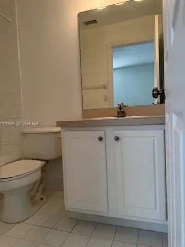 a bathroom with a sink a toilet and mirror