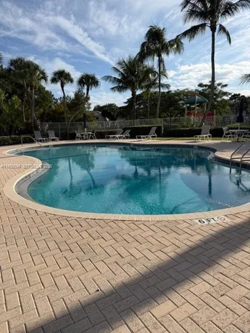 a view of swimming pool with outdoor seating and plants