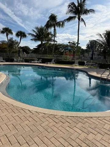a view of swimming pool with a table and chairs