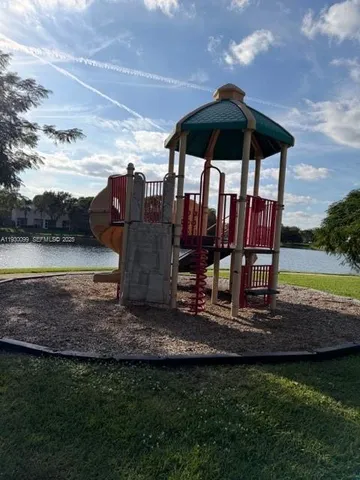 a view of a two chairs under an umbrella in backyard