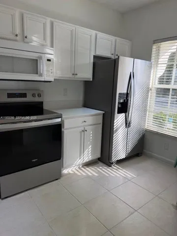 a kitchen with a stove and a refrigerator