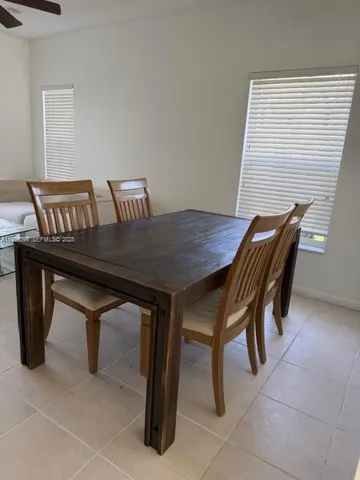 a view of a dining room with furniture and a window