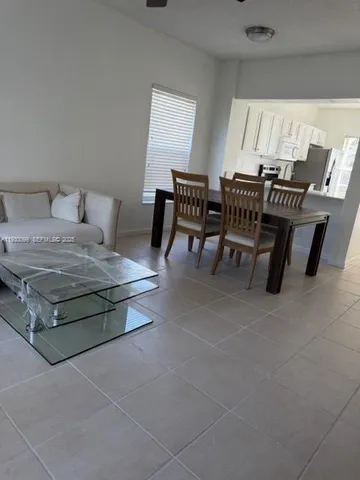 a living room with a table and chairs