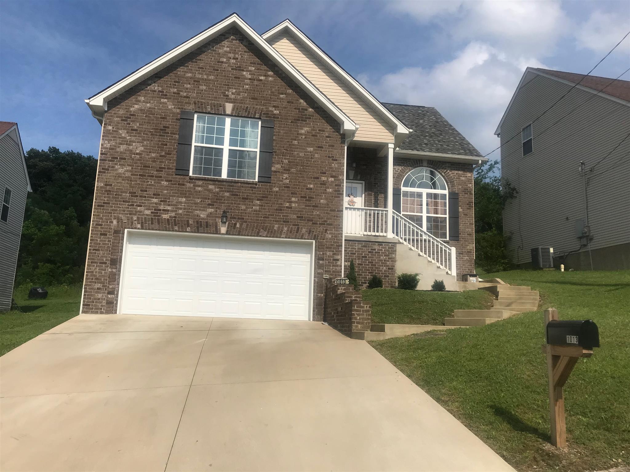 1013 Ridge Trail Goodlettsville, TN 37072 - Photo 1 of 17 a front view of a house with garden