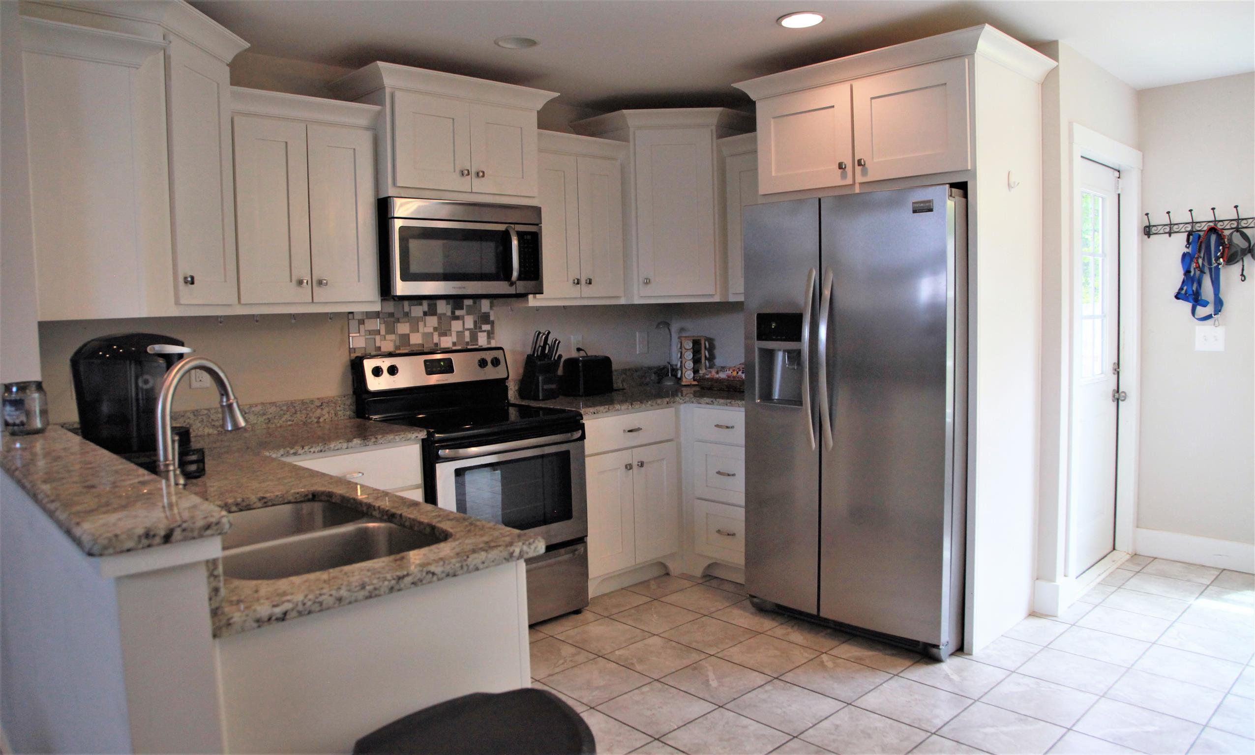1013 Ridge Trail Goodlettsville, TN 37072 - Photo 3 of 17 a kitchen with a refrigerator sink and cabinets