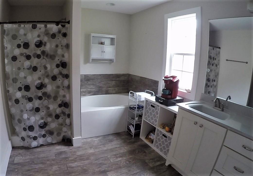 1013 Ridge Trail Goodlettsville, TN 37072 - Photo 7 of 17 a bathroom with a bathtub sink and mirror