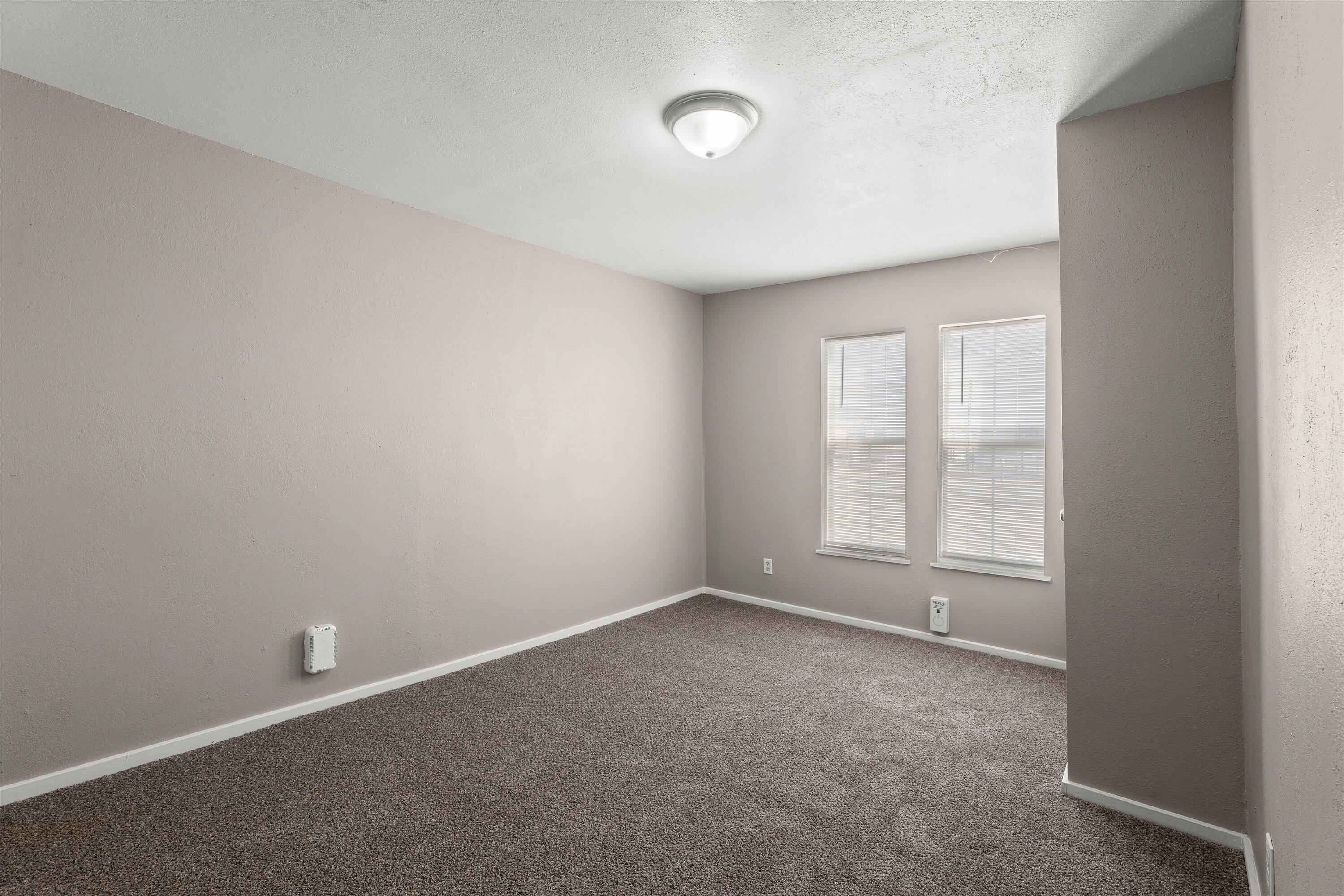 301 Austin Street Levelland, TX 79336 - Photo 11 of 18 an empty room with a empty space and a window