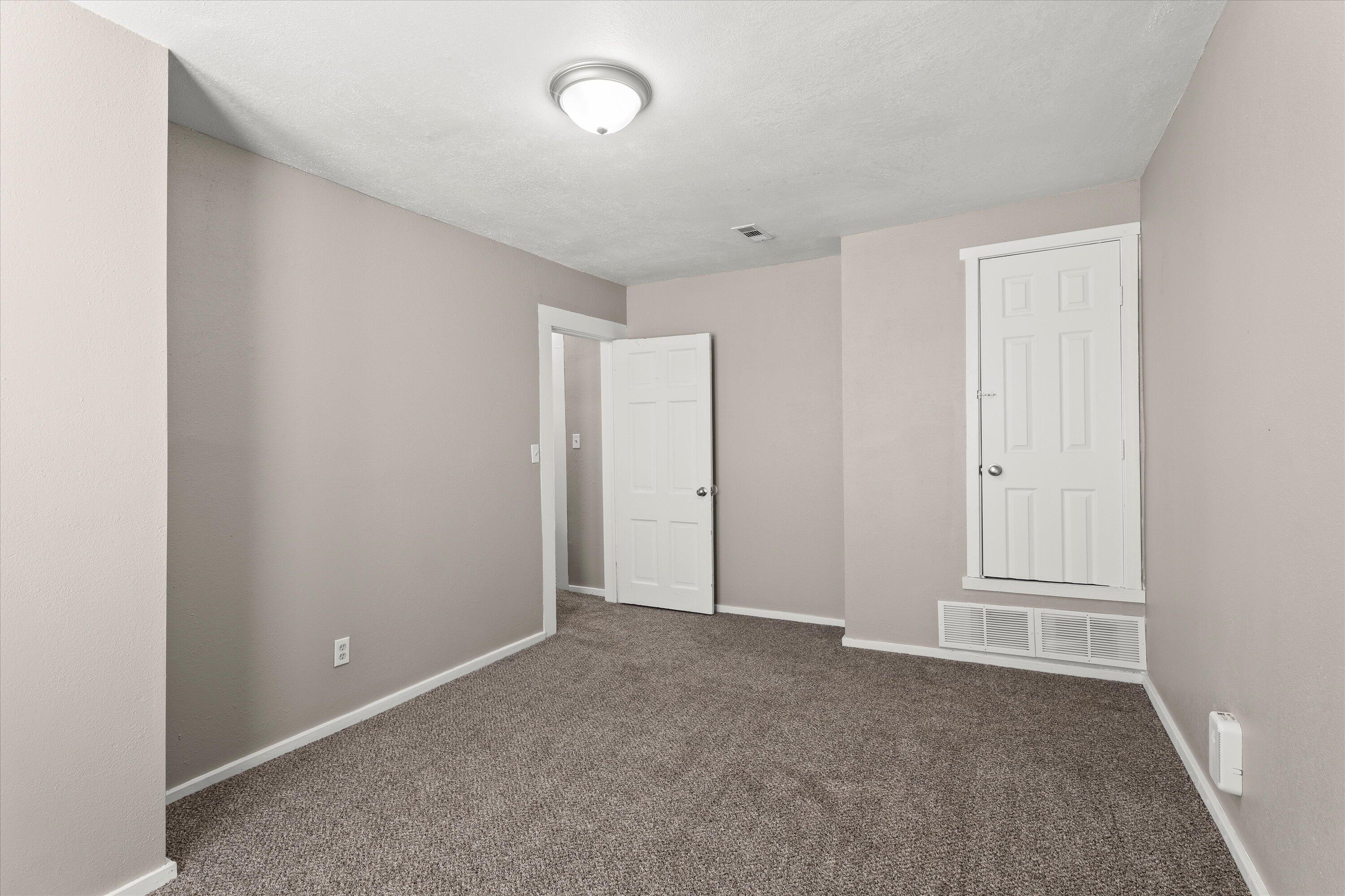 301 Austin Street Levelland, TX 79336 - Photo 12 of 18 an empty room with windows
