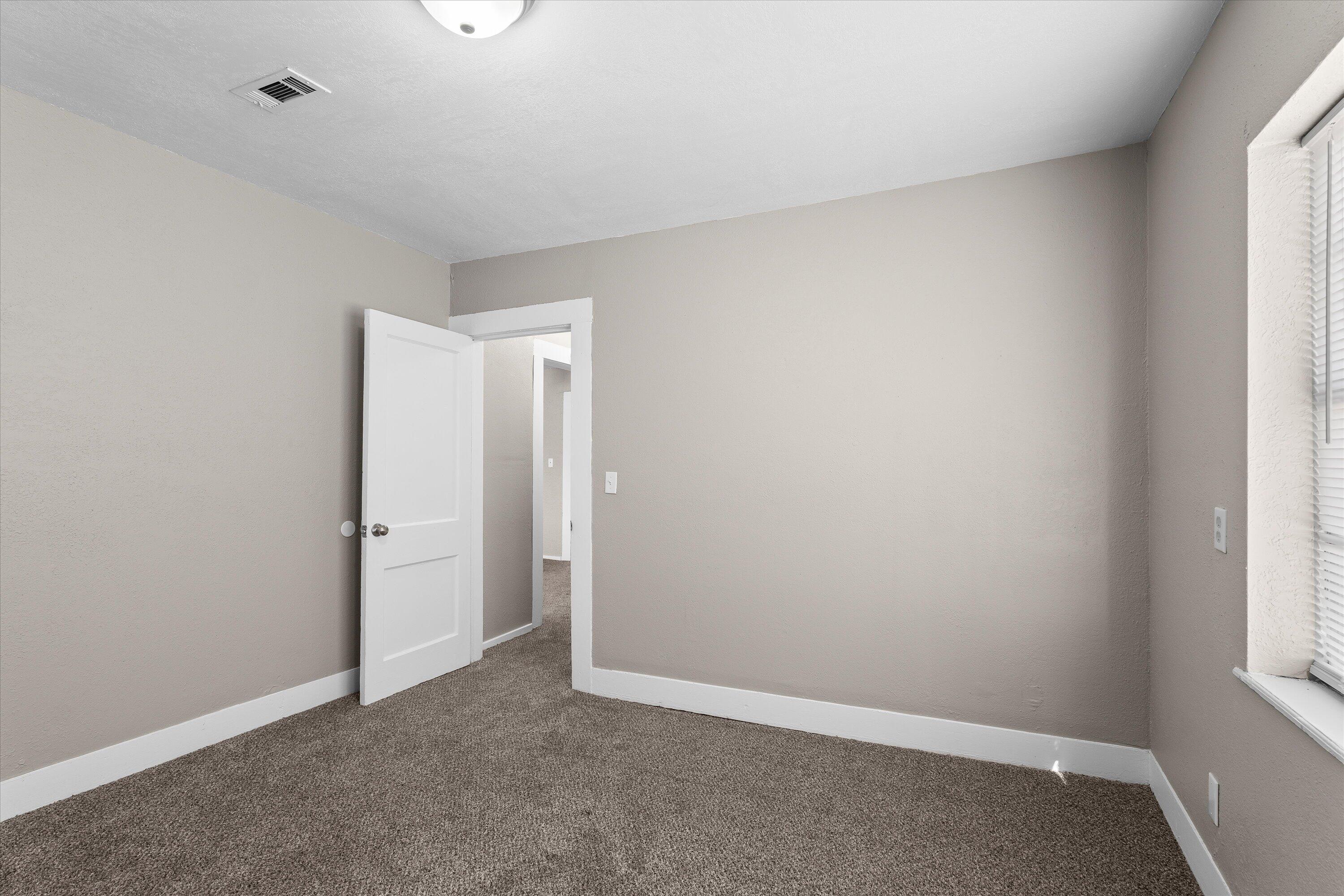 301 Austin Street Levelland, TX 79336 - Photo 15 of 18 an empty room with windows