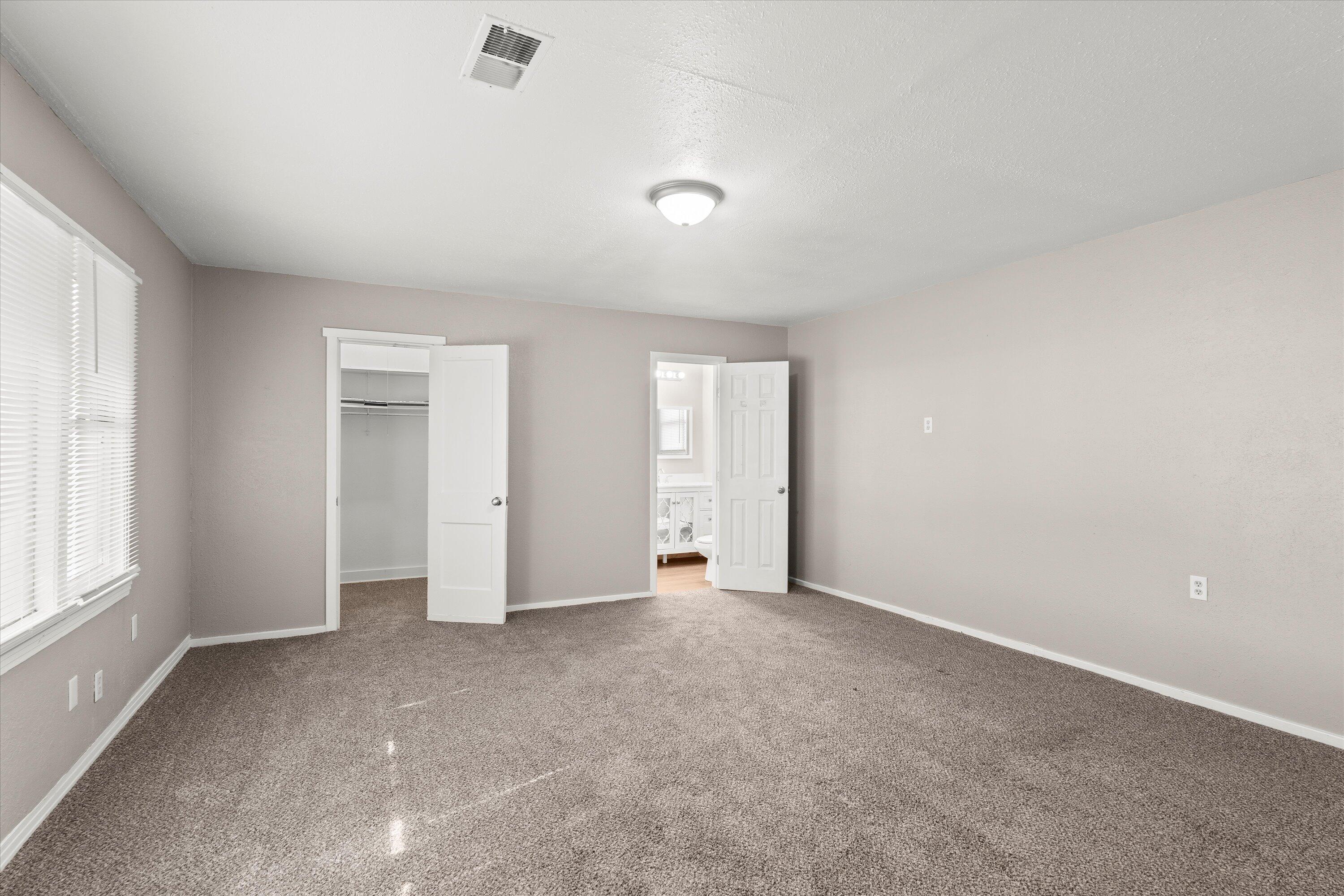 301 Austin Street Levelland, TX 79336 - Photo 8 of 18 an empty room with windows