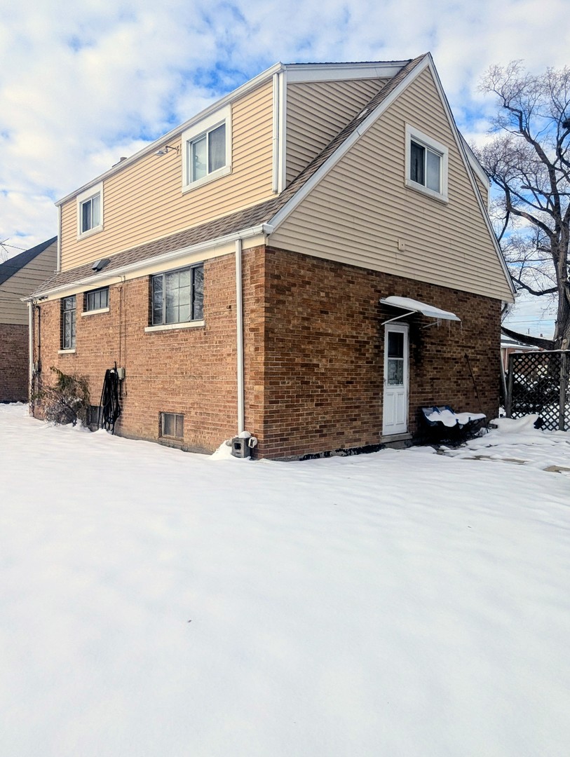 3253 Bernice Road Lansing, IL 60438 - Photo 3 of 20 a front view of a house with a yard and garage