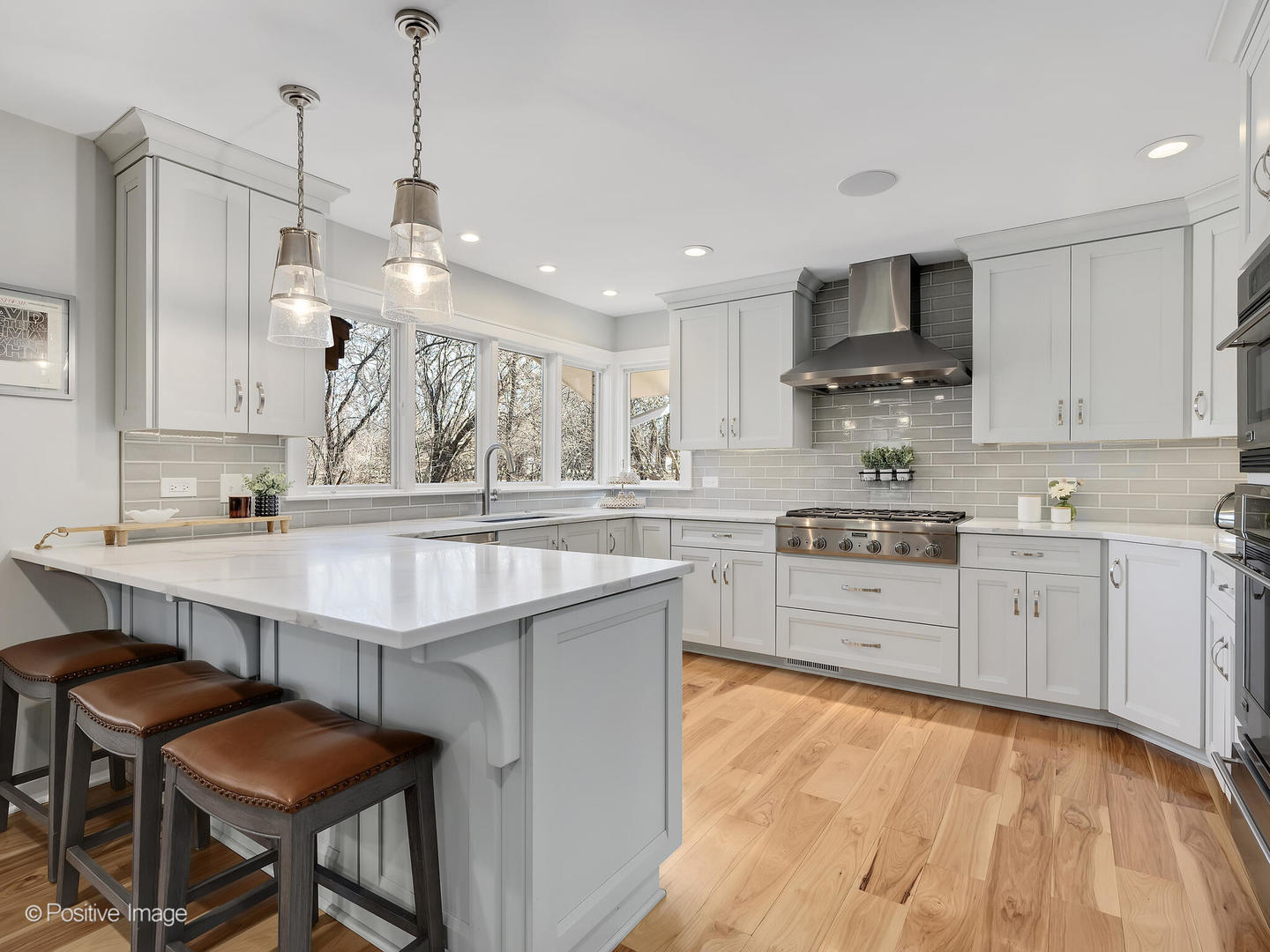 6555 Shabbona Road Indian Head Park, IL 60525 - Photo 21 of 63 a kitchen with kitchen island a sink table and chairs