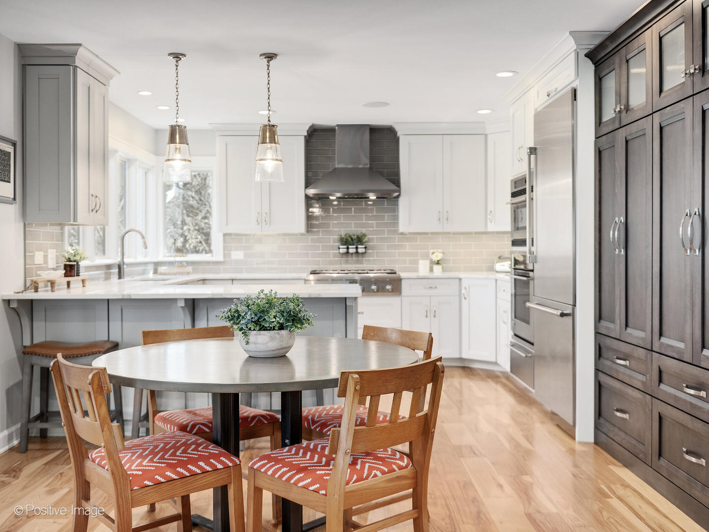6555 Shabbona Road Indian Head Park, IL 60525 - Photo 22 of 63 a kitchen with stainless steel appliances kitchen island granite countertop a dining table chairs and a refrigerator
