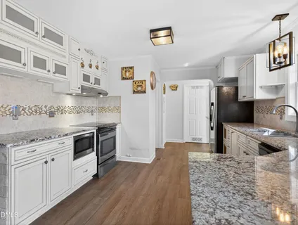 a kitchen with stainless steel appliances granite countertop a stove and a sink