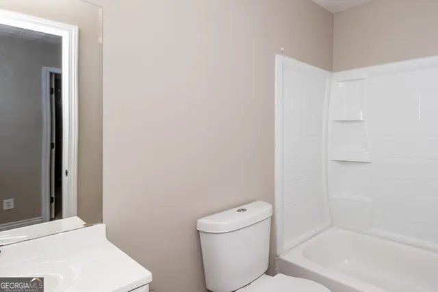 a bathroom with a toilet and a bathtub