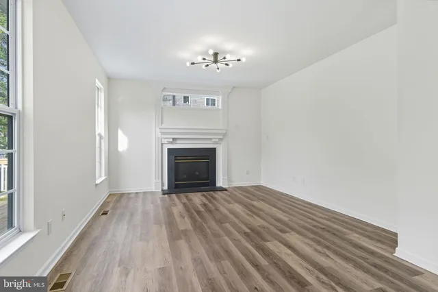 a view of empty room with fireplace