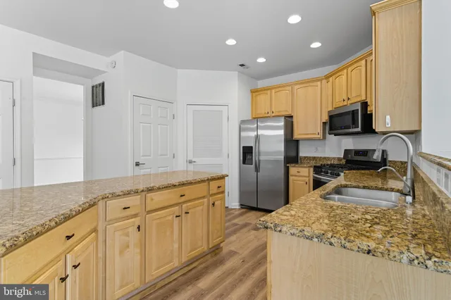 a kitchen with sink refrigerator and microwave