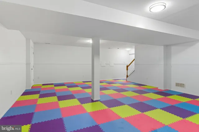 a room with pool table and windows