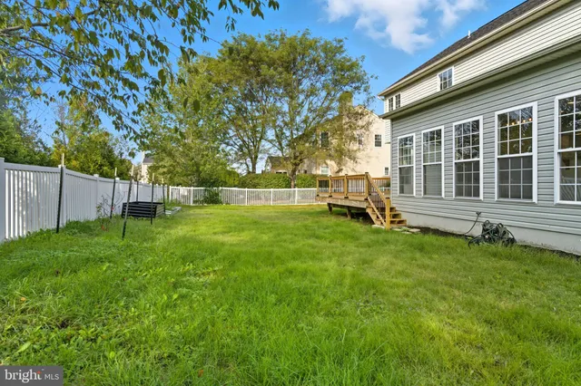 a view of a backyard with a garden and deck