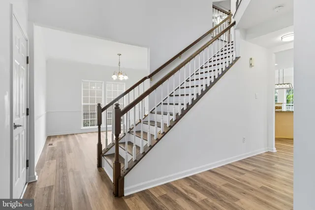 a view of entryway and hall with wooden floor