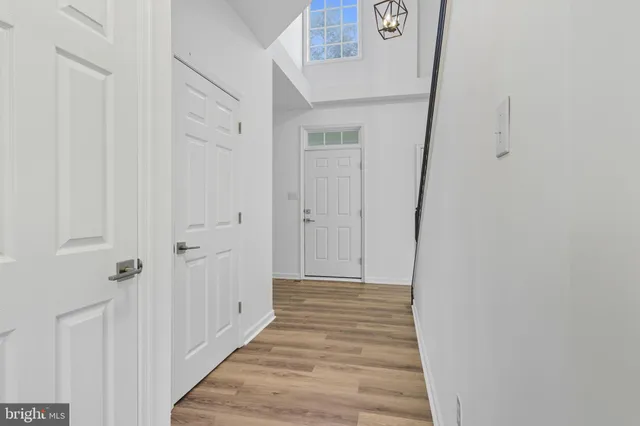 a view of a hallway with wooden floor