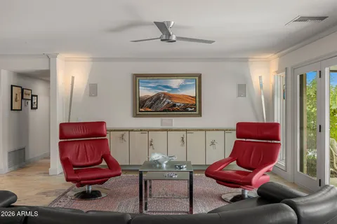 a living room with furniture and a chair