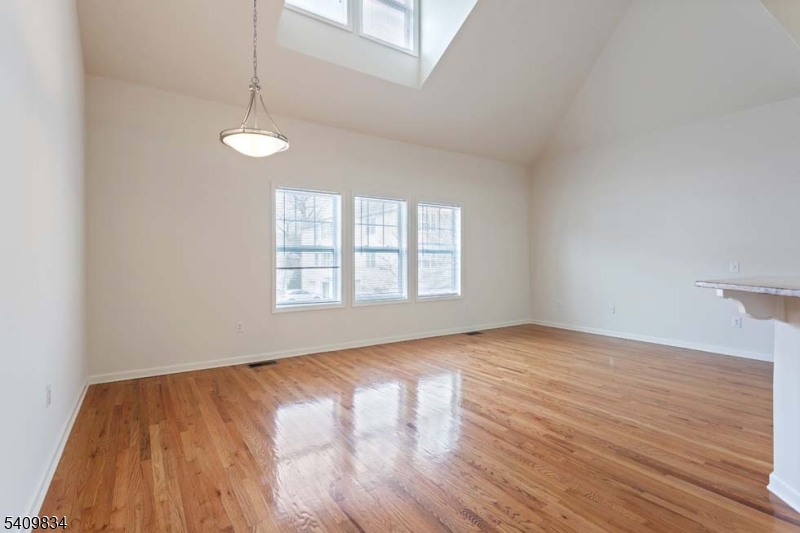 35 Pine Lane Springfield, NJ 07081 - Photo 3 of 5 a view of an empty room with wooden floor and a window