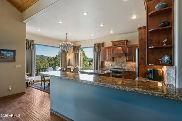 a kitchen with stainless steel appliances granite countertop a stove refrigerator and cabinets