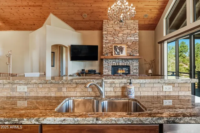 a dining room with furniture a rug and a floor to ceiling window