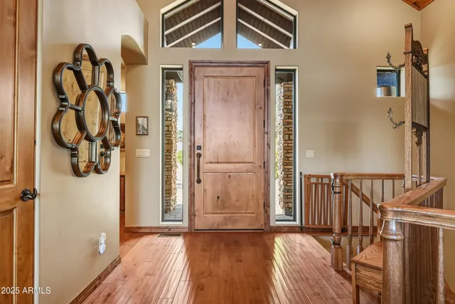 a view of a bedroom with wooden floor and furniture
