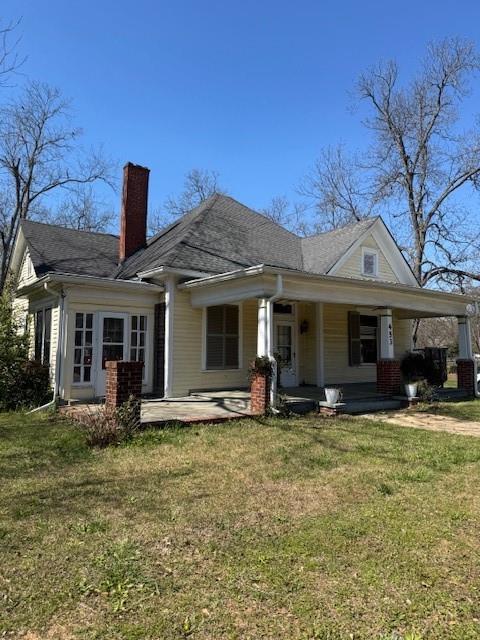 a front view of a house with a garden and porch