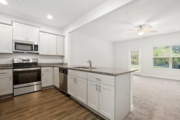 a kitchen with a refrigerator stove and microwave